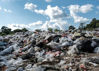 garbage-rock-by-road-against-sky